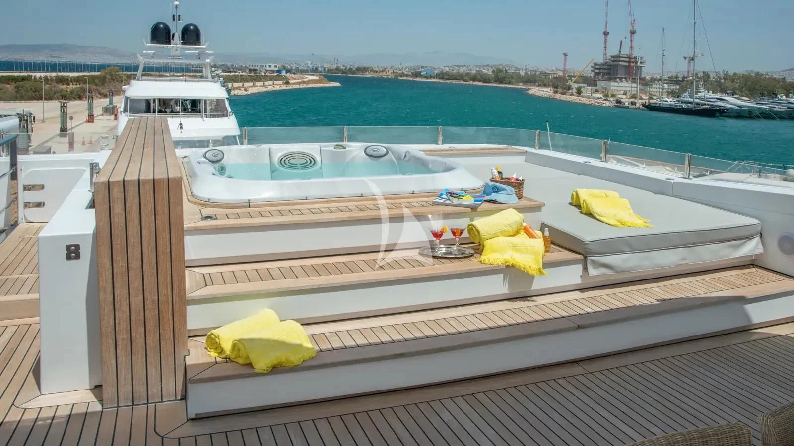 a deck with a boat and a yellow towel on it aboard IPANEMAS Yacht for Sale