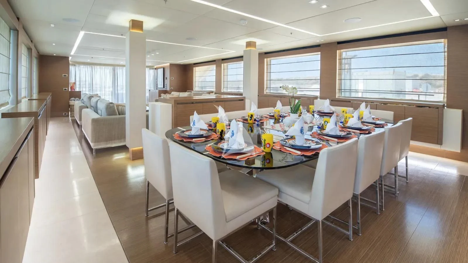 a large dining room with white chairs aboard IPANEMAS Yacht for Sale