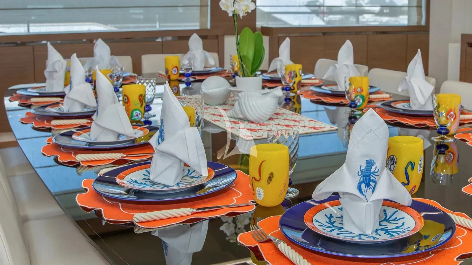 a table with many plates and cups aboard IPANEMAS Yacht for Sale
