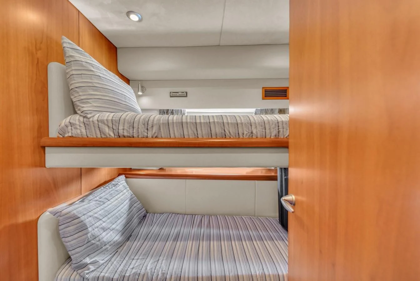 a bed with a white sheet aboard 82' SUNSEEKER PREDATOR 82 Yacht for Sale