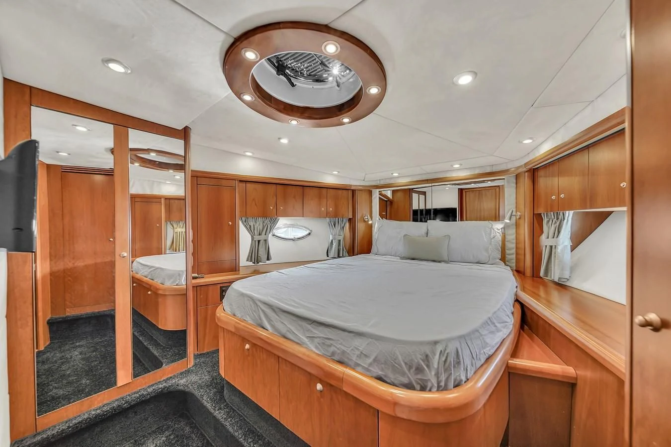 a bedroom with a bed and a mirror aboard 82' SUNSEEKER PREDATOR 82 Yacht for Sale