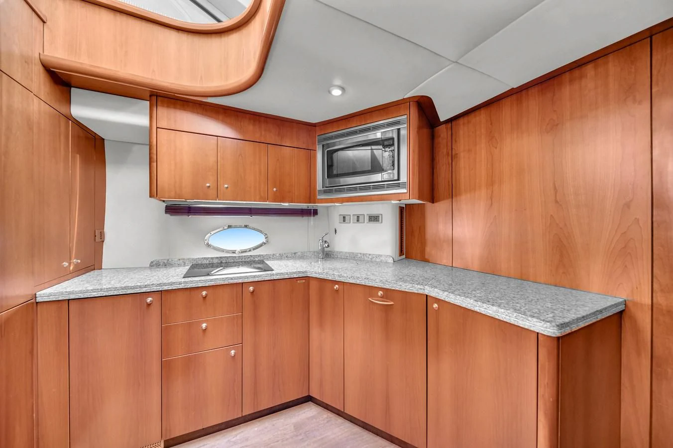 a kitchen with wooden cabinets aboard 82' SUNSEEKER PREDATOR 82 Yacht for Sale
