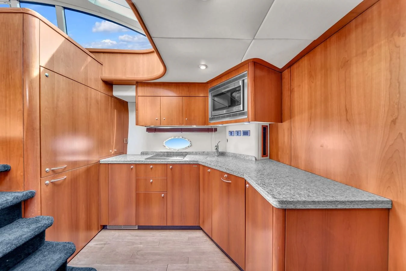 a kitchen with wooden cabinets aboard 82' SUNSEEKER PREDATOR 82 Yacht for Sale