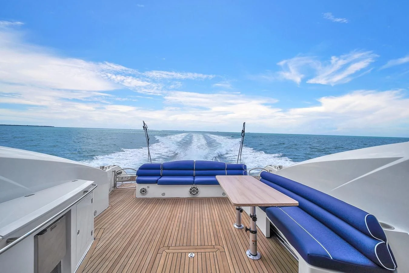 a deck with a table and chairs on it by the water aboard 82' SUNSEEKER PREDATOR 82 Yacht for Sale