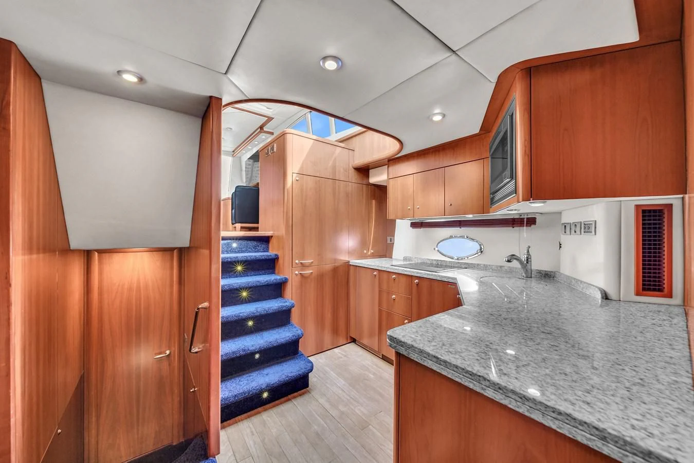 a kitchen with wooden cabinets aboard 82' SUNSEEKER PREDATOR 82 Yacht for Sale