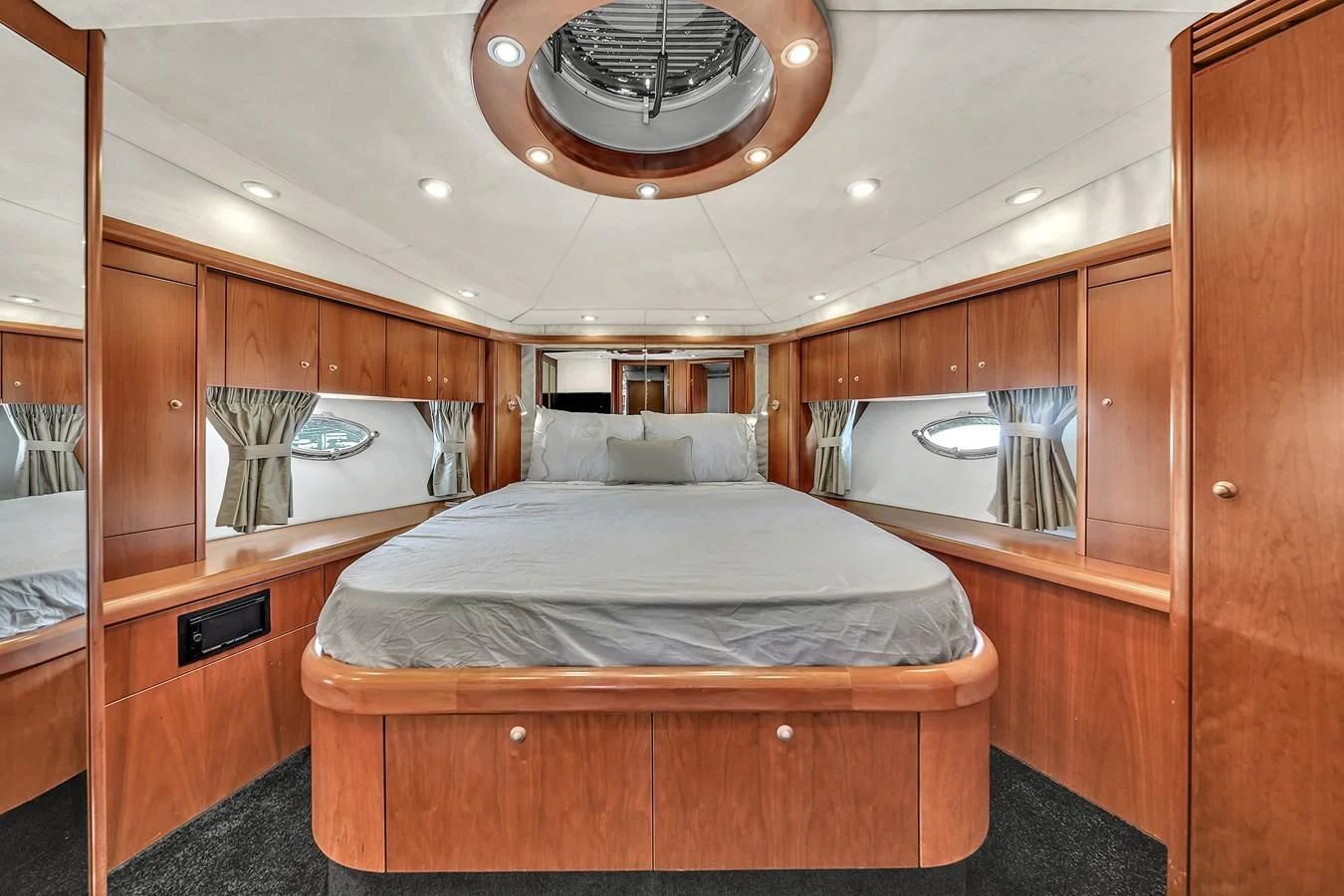 a bedroom with a bed and a mirror aboard 82' SUNSEEKER PREDATOR 82 Yacht for Sale