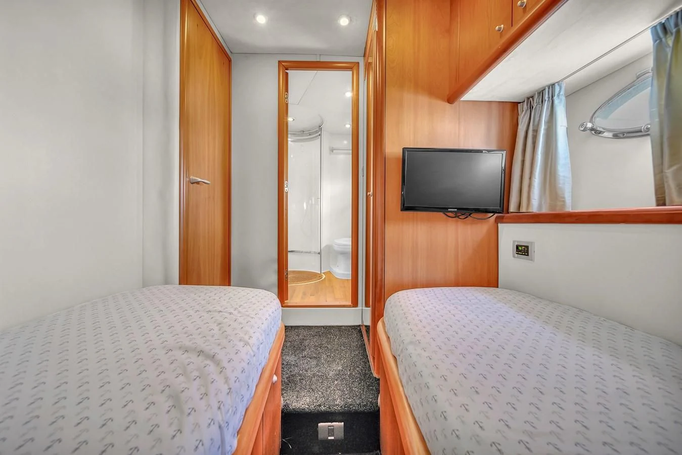 a bedroom with a bed and a television aboard 82' SUNSEEKER PREDATOR 82 Yacht for Sale