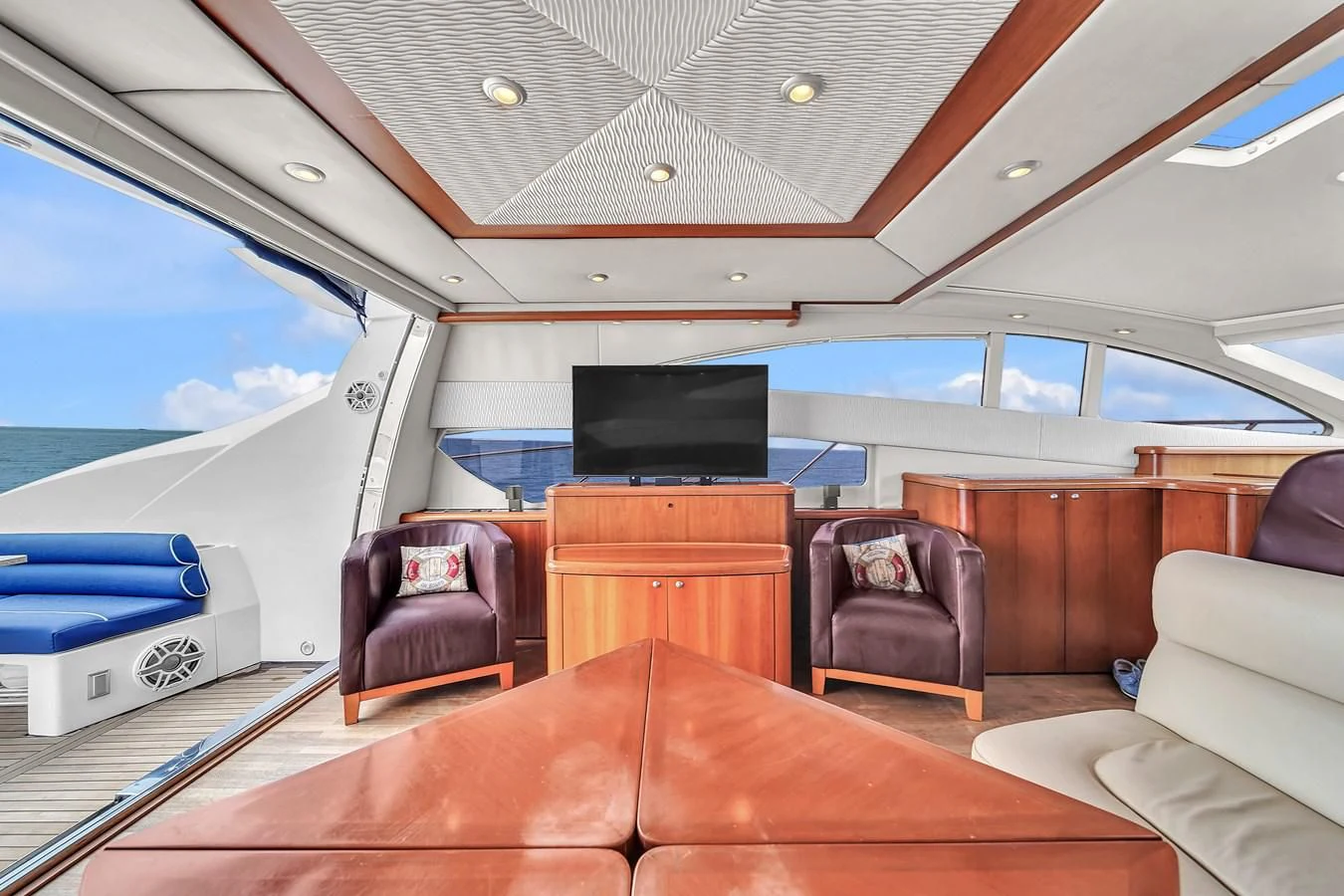 inside of a vehicle with a couch and a tv on the wall aboard 82' SUNSEEKER PREDATOR 82 Yacht for Sale