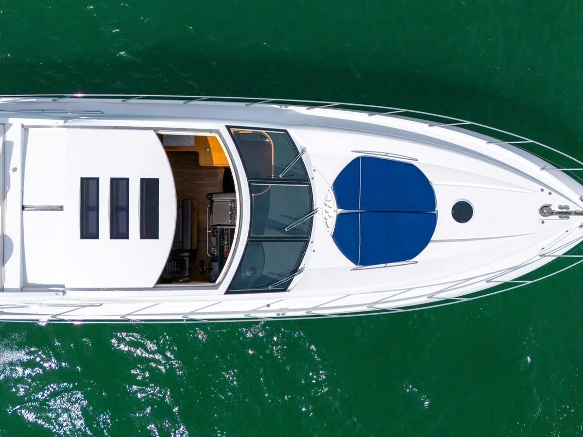 a white boat with a blue logo aboard 82' SUNSEEKER PREDATOR 82 Yacht for Sale