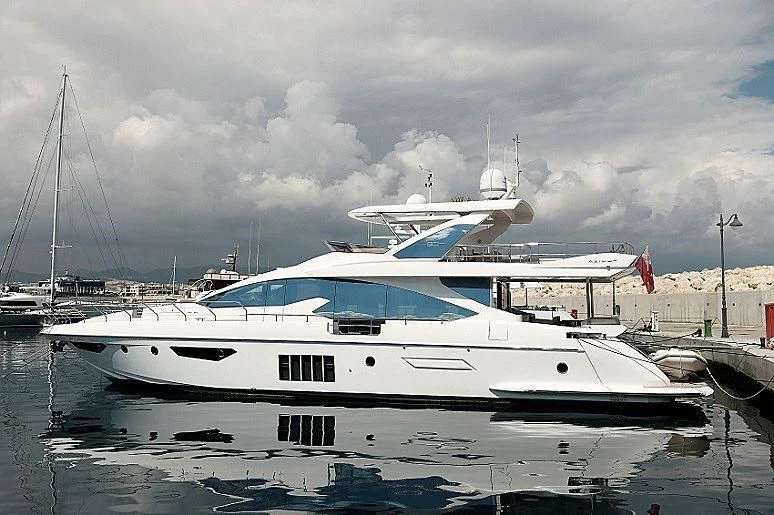 a white yacht in a harbor aboard FREE MIND Yacht for Sale