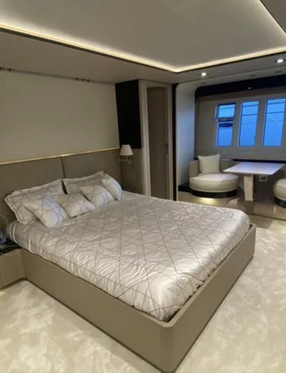 a bed with white sheets aboard FREE MIND Yacht for Sale