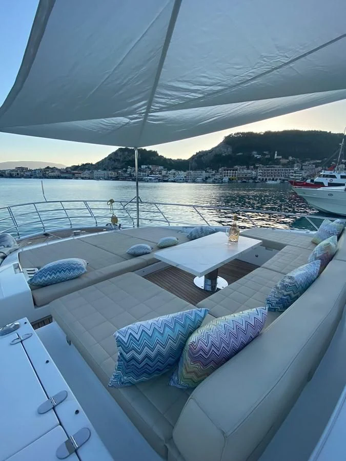 a large white lounge chair on a deck overlooking a body of water aboard FREE MIND Yacht for Sale