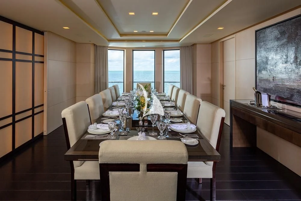 a dining room with a table aboard SIREN Yacht for Sale