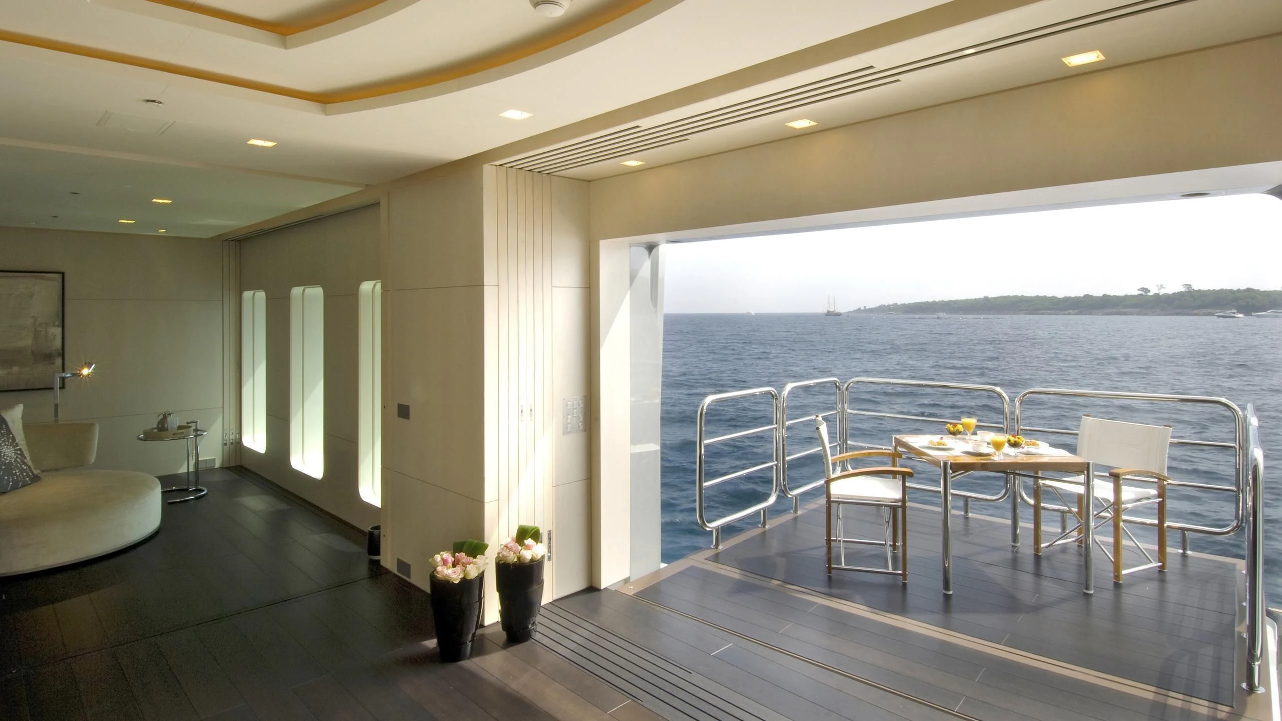 a room with a table and chairs aboard SIREN Yacht for Sale