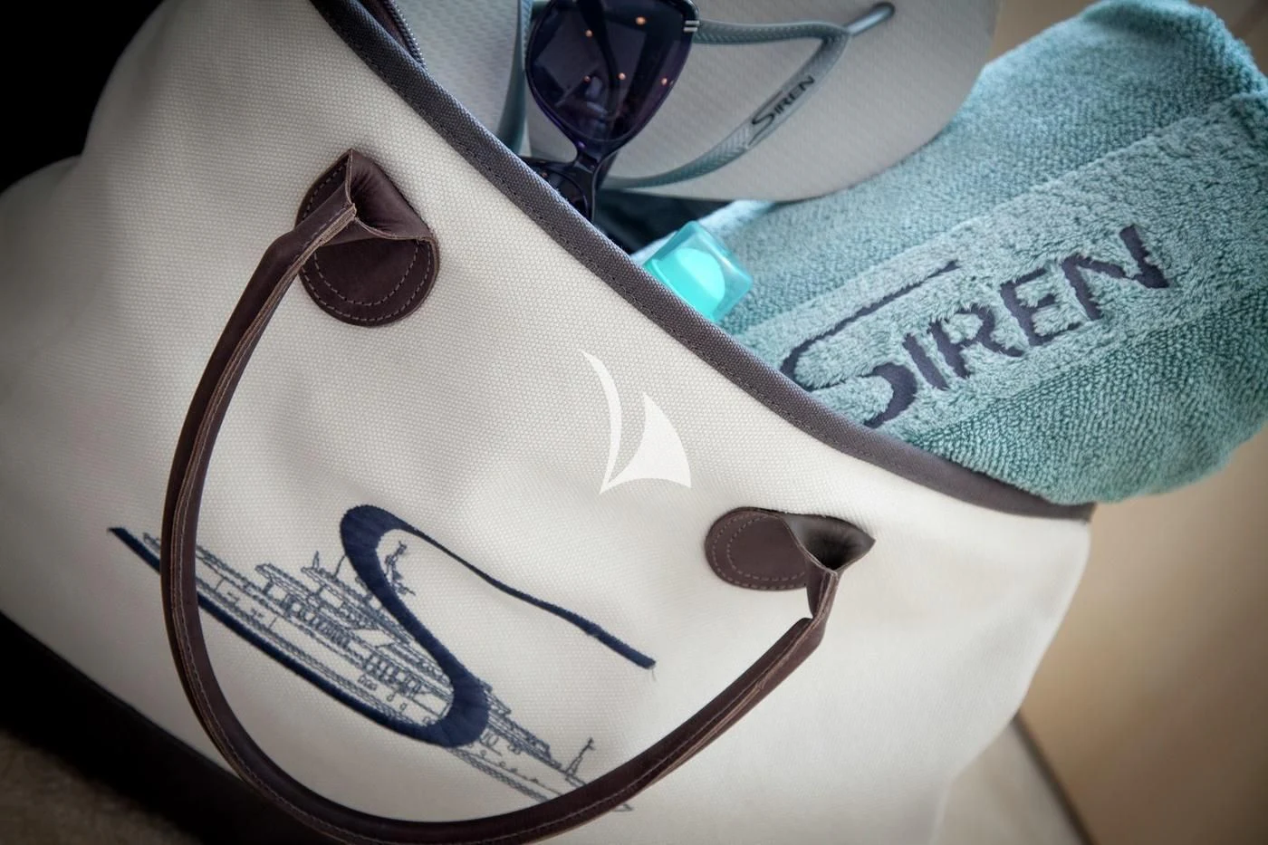 a pair of glasses on a person's lap aboard SIREN Yacht for Sale