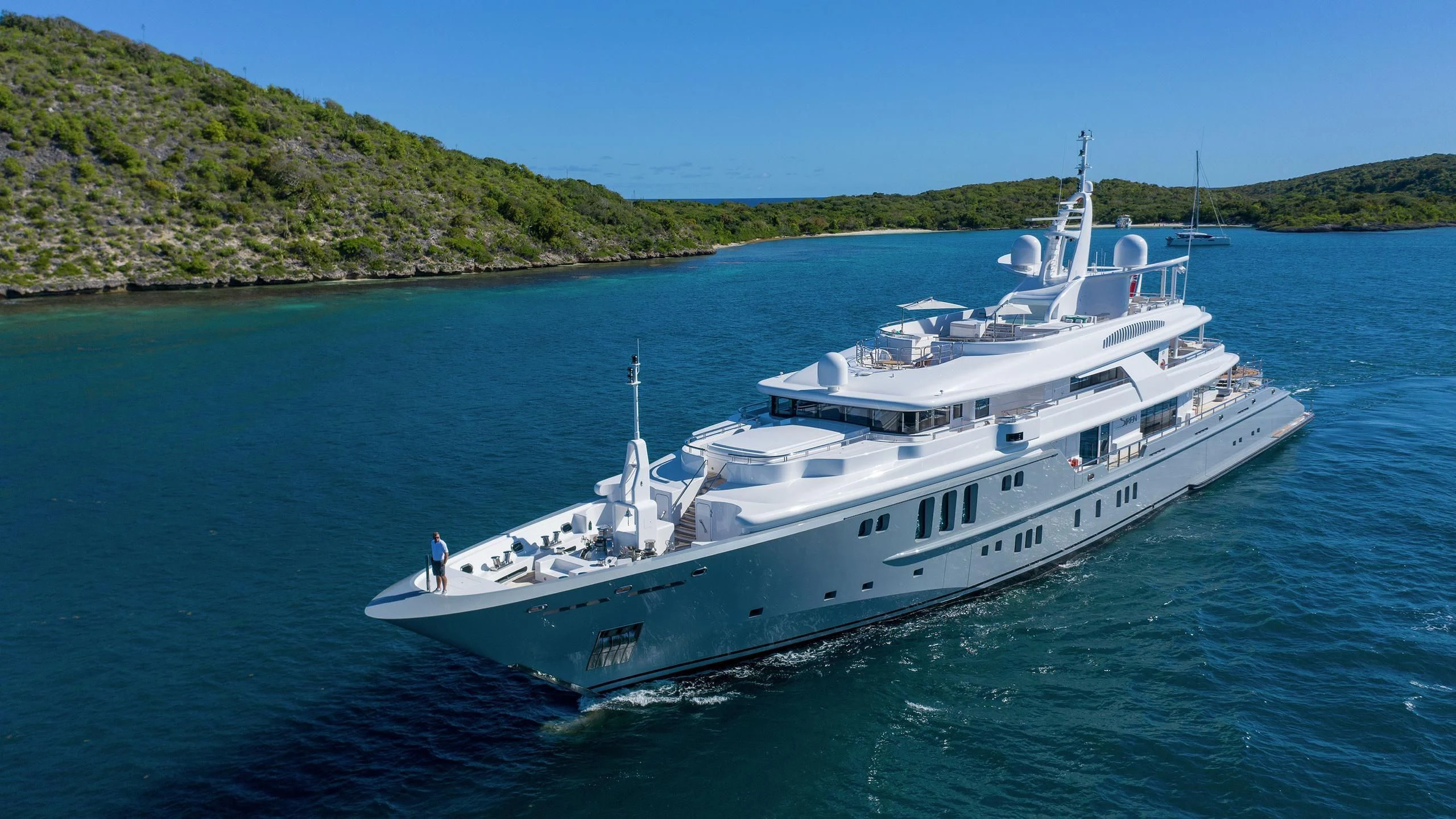 a large white boat in the water aboard SIREN Yacht for Sale