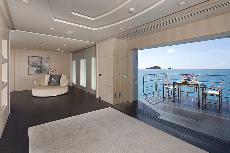a large living room with a large balcony aboard SIREN Yacht for Sale