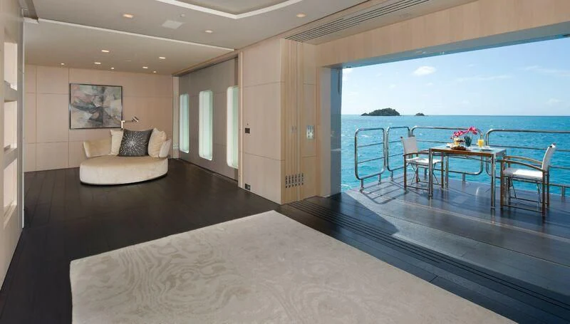 a large living room with a balcony aboard SIREN Yacht for Sale