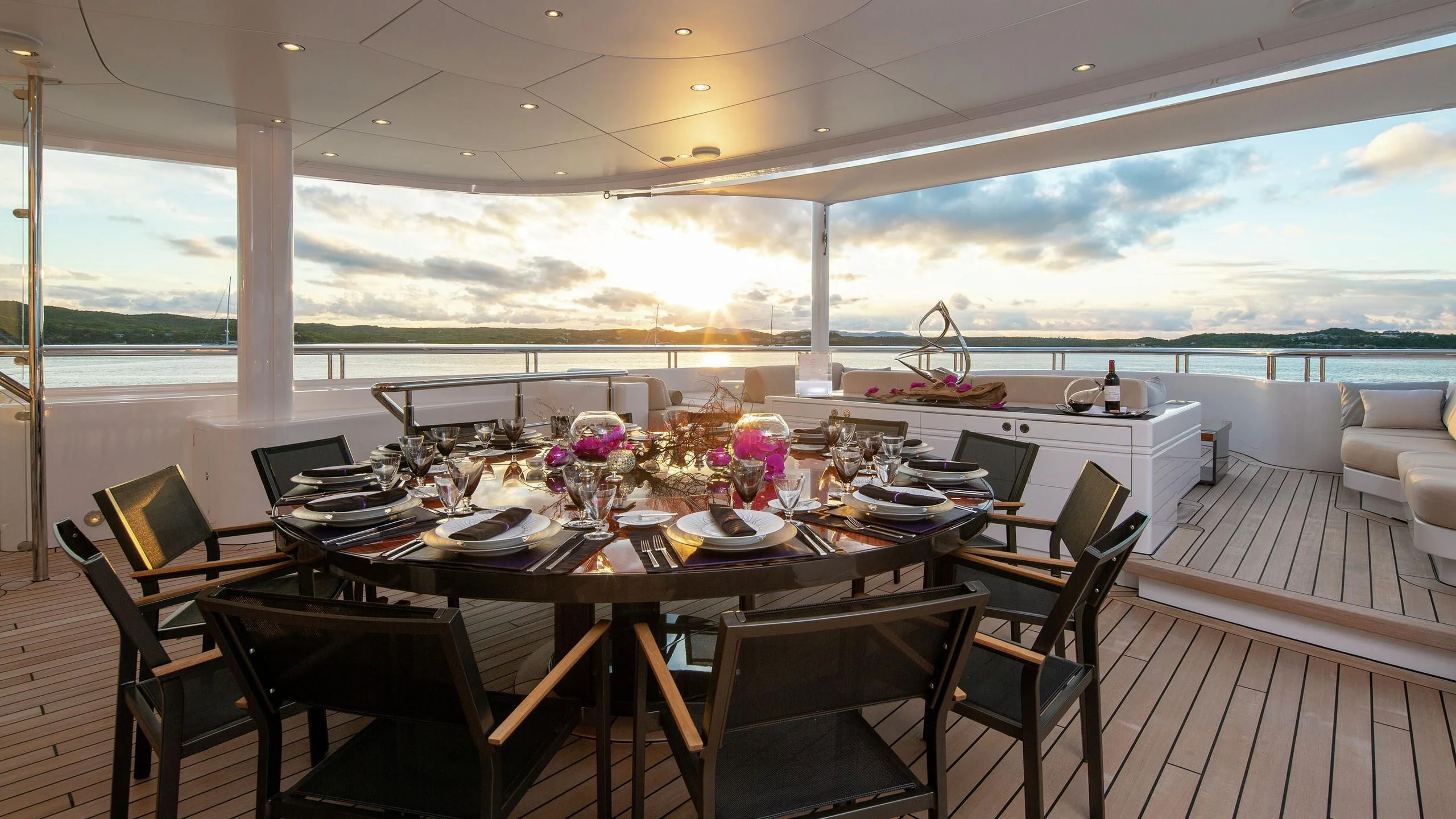a dining table on a deck aboard SIREN Yacht for Sale