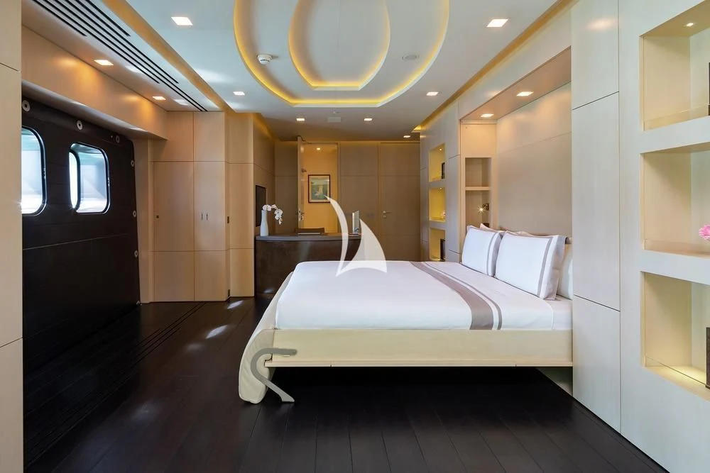 a room with a bed and a mirror aboard SIREN Yacht for Sale