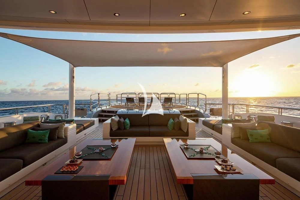a room with a view of the ocean and a large ship aboard SIREN Yacht for Sale