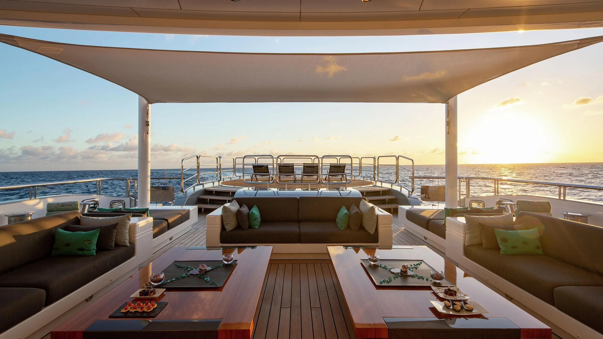 a room with a view of the ocean and a large bed aboard SIREN Yacht for Sale