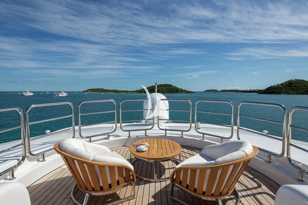 a boat with chairs and a table on the deck aboard SIREN Yacht for Sale