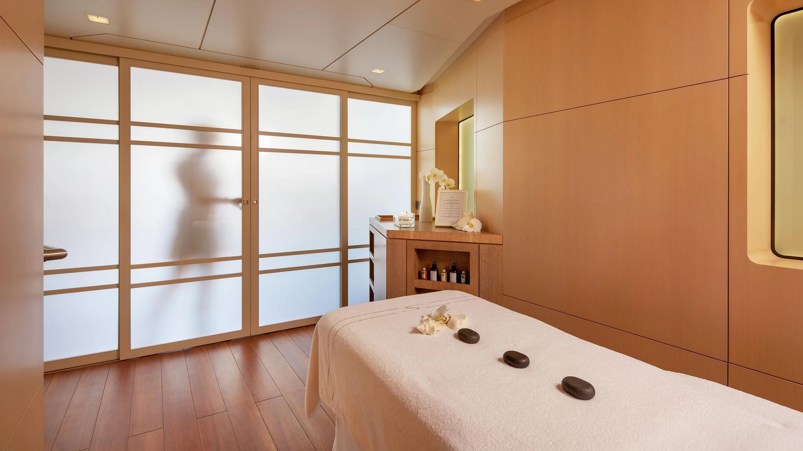 a room with a bed and a mirror aboard SIREN Yacht for Sale