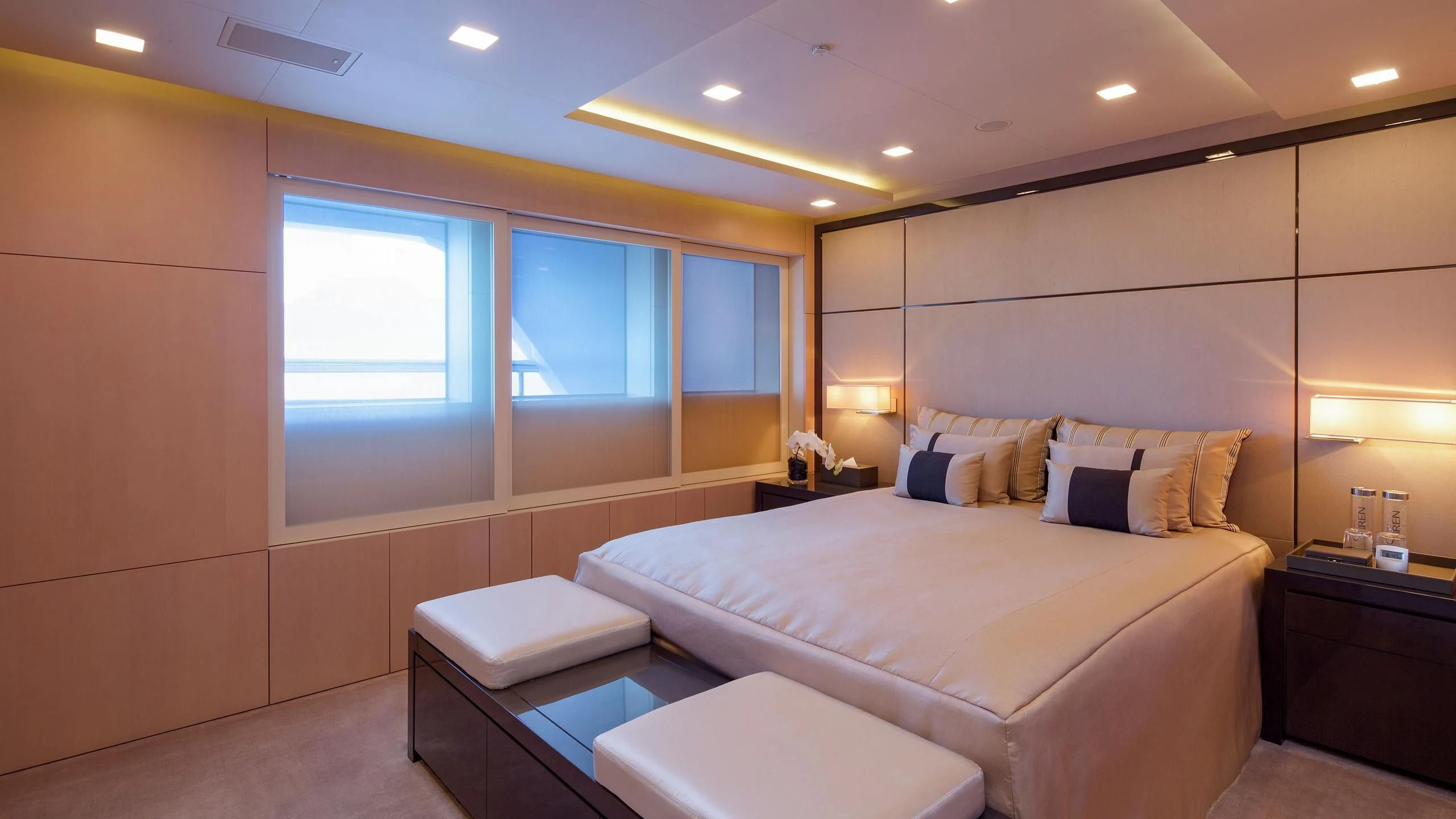 a bedroom with a bed and a window aboard SIREN Yacht for Sale