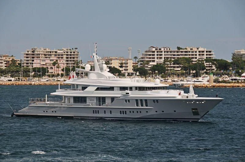 a large white boat on the water aboard SIREN Yacht for Sale
