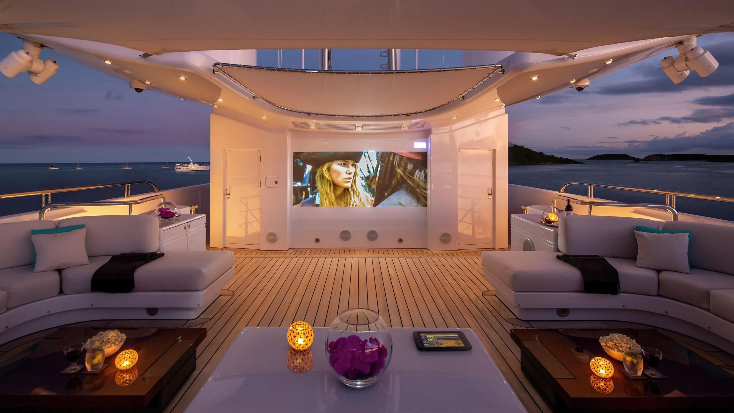 a room with a table and couches aboard SIREN Yacht for Sale