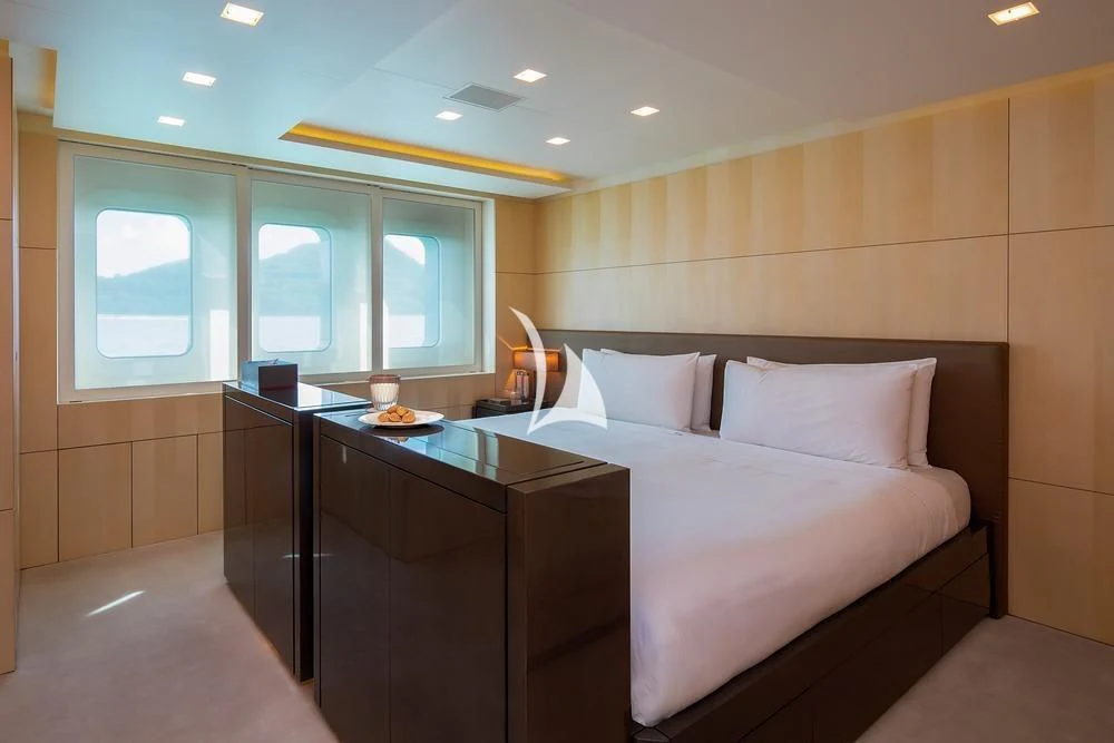 a room with a bed and desk aboard SIREN Yacht for Sale