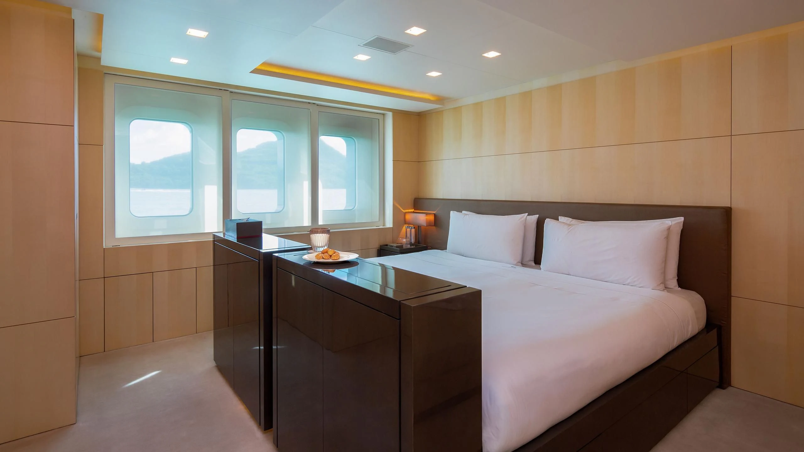a room with a bed and desk aboard SIREN Yacht for Sale