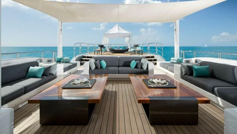 a living room with a large balcony aboard SIREN Yacht for Sale