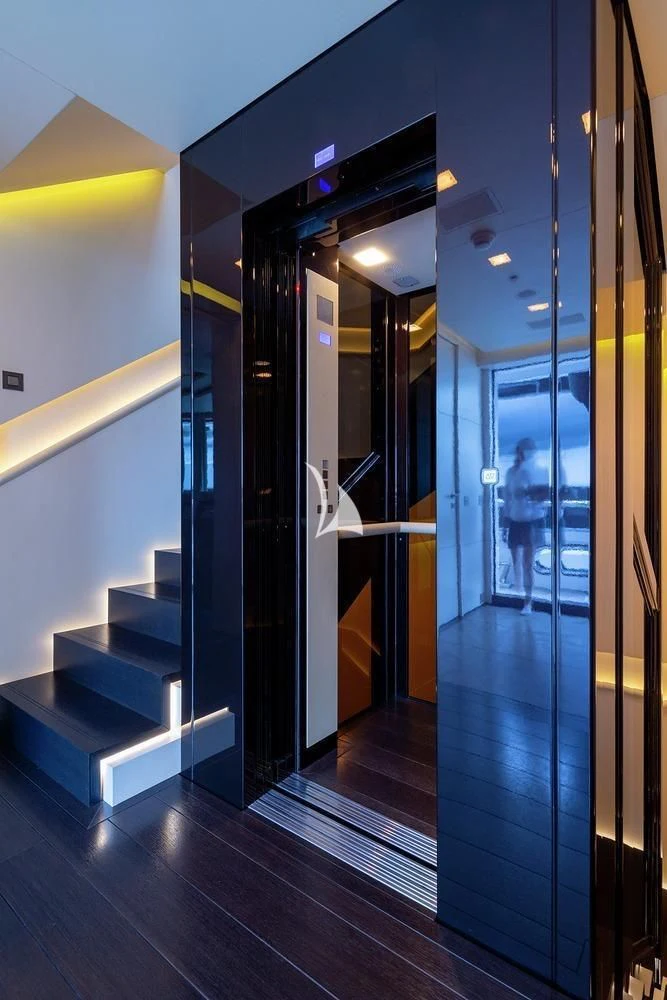 a hallway with glass doors aboard SIREN Yacht for Sale