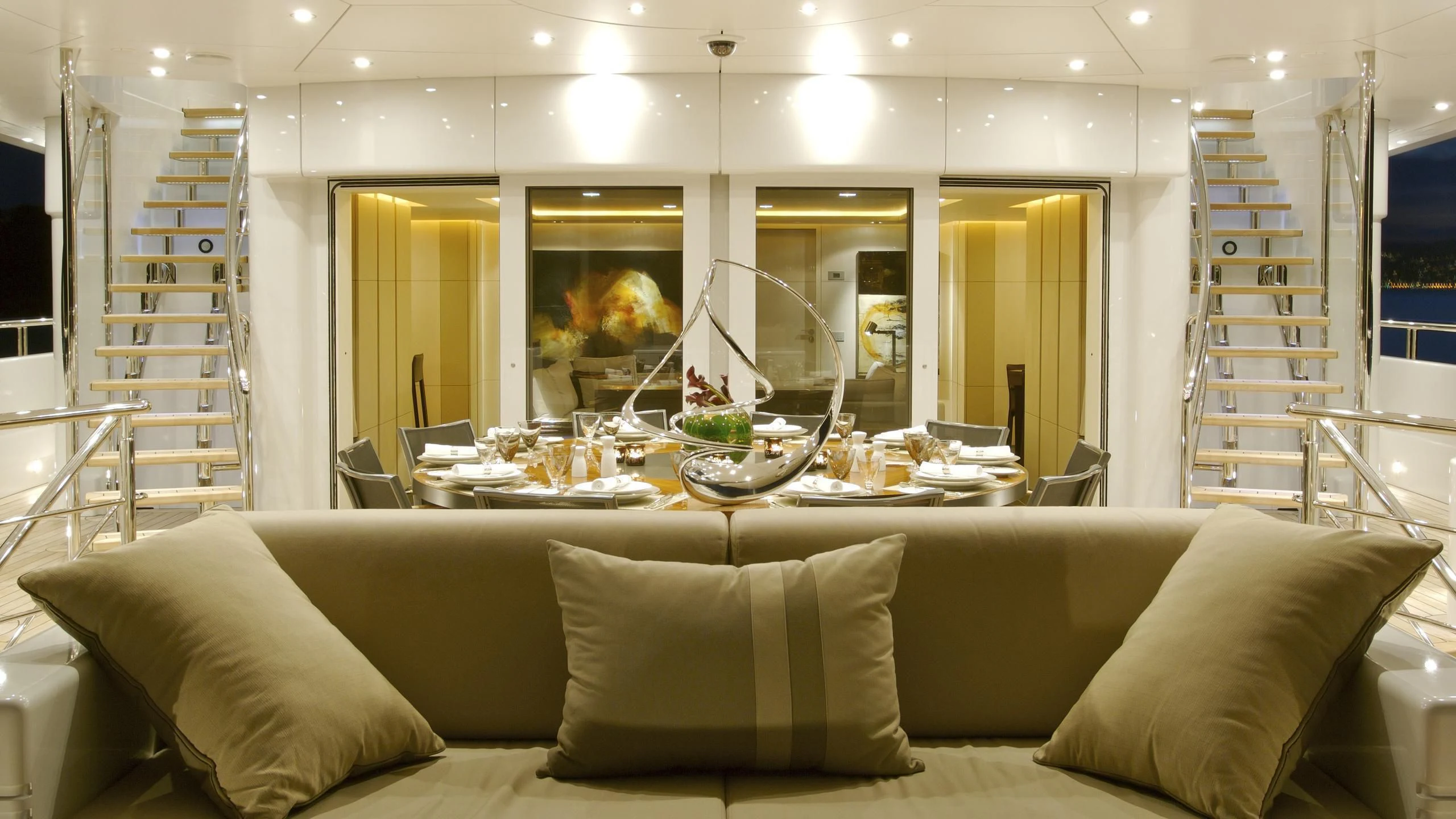 a living room with a large white sofa and a large window aboard SIREN Yacht for Sale