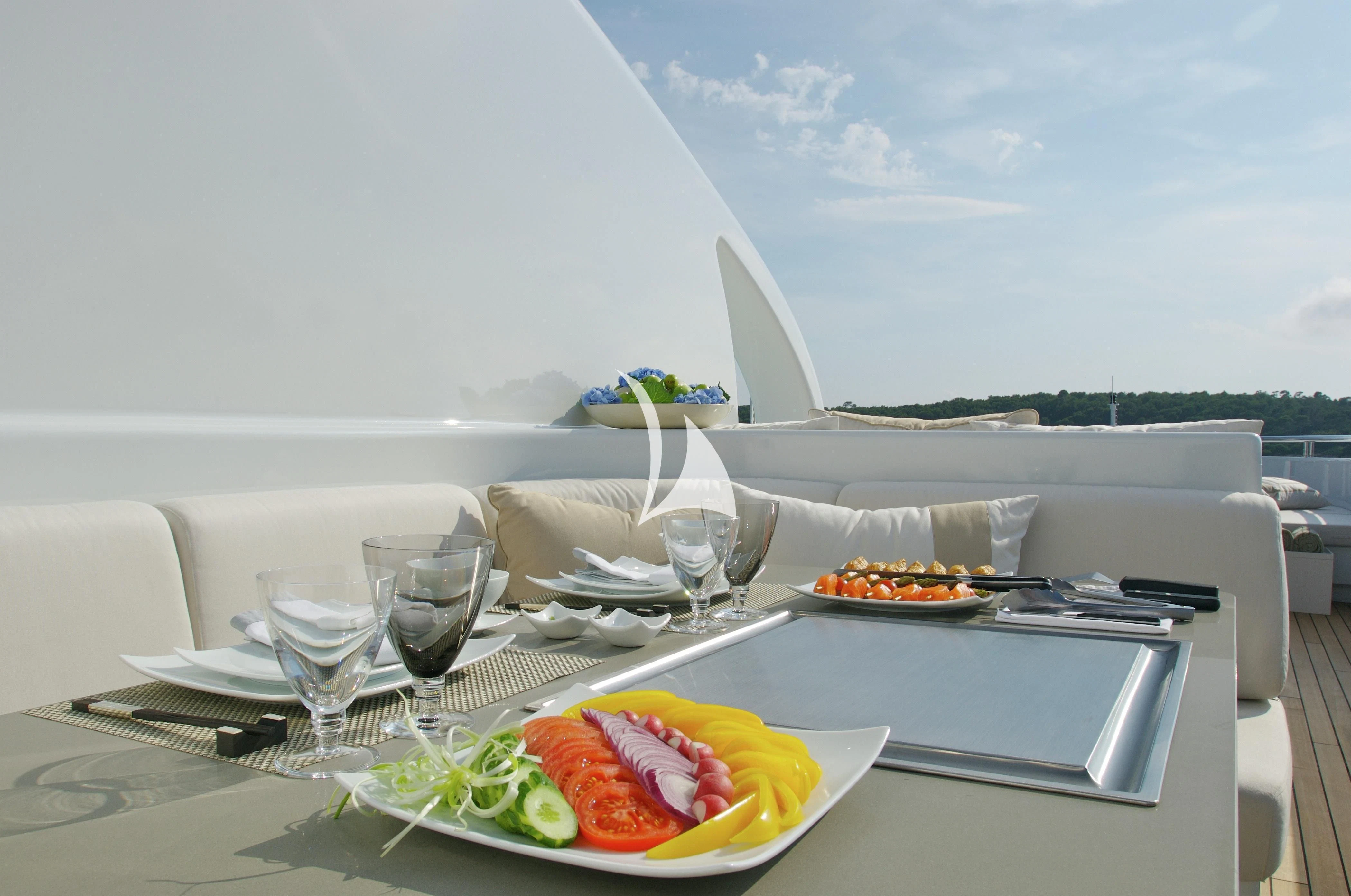 a table with food and glasses on it aboard SIREN Yacht for Sale