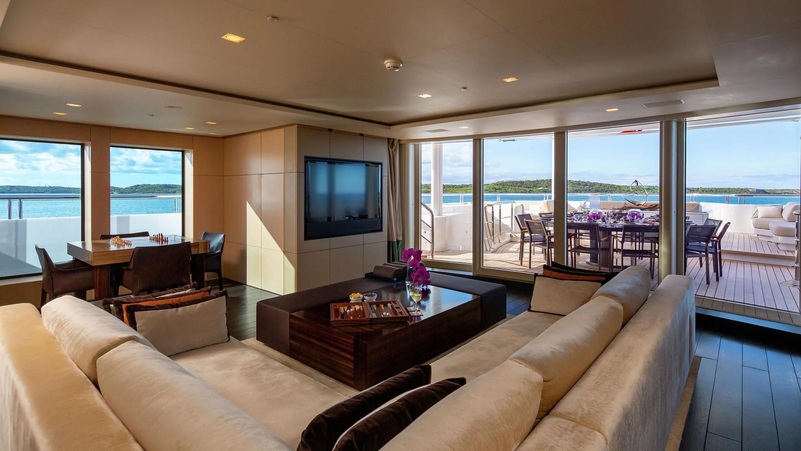 a living room with a large window aboard SIREN Yacht for Sale