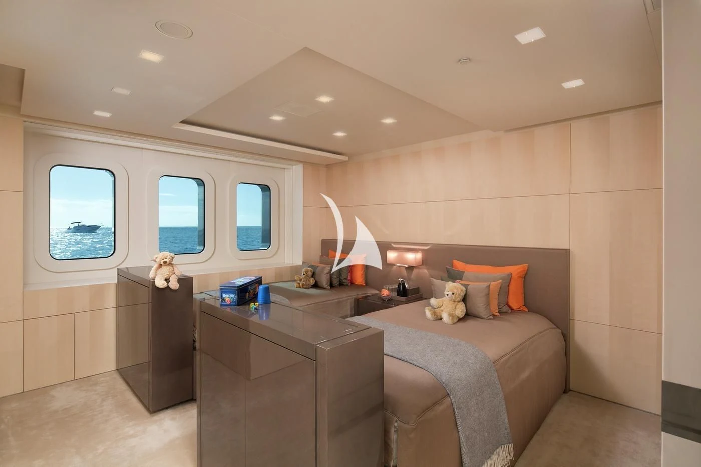 a bedroom with a desk and a bed aboard SIREN Yacht for Sale