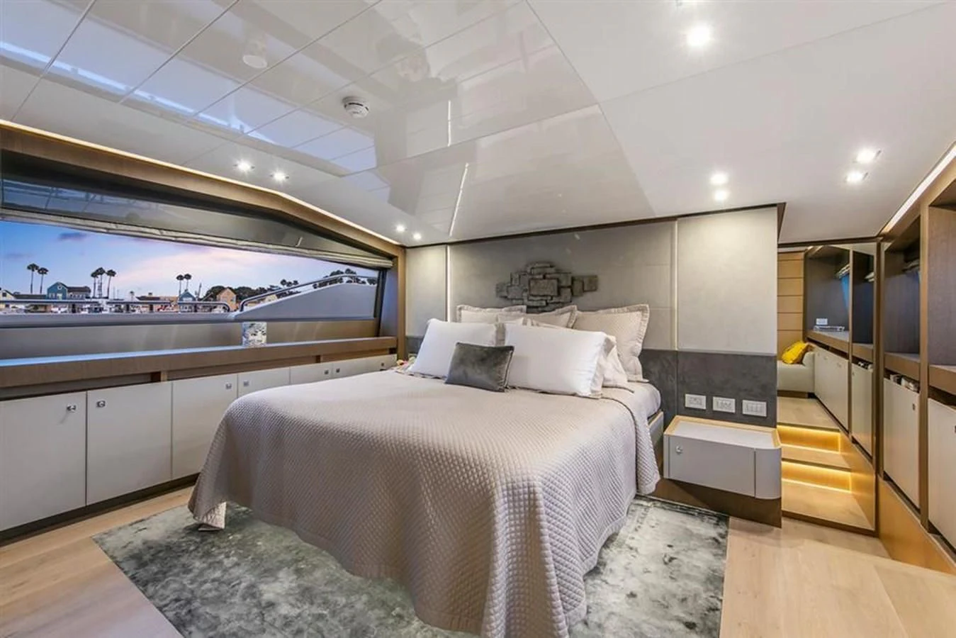 a bedroom with a large window aboard LONTANO Yacht for Sale