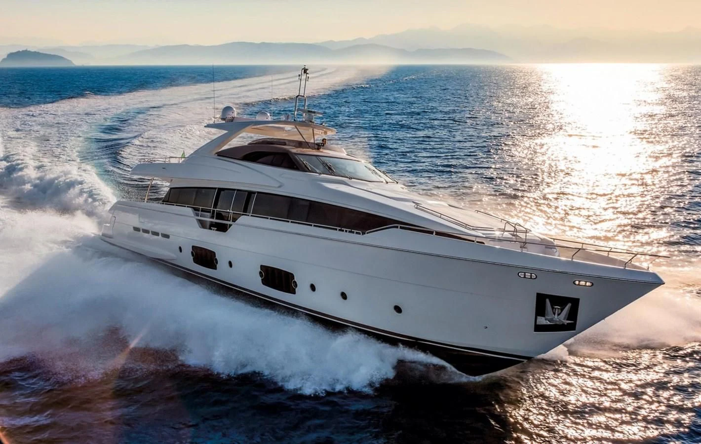 a white yacht on the water aboard LONTANO Yacht for Sale