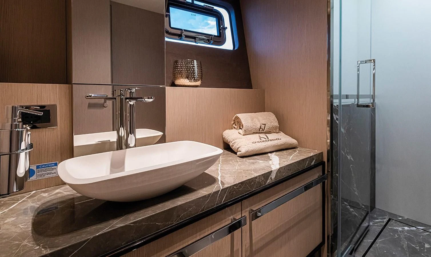 a bathroom with a sink and a mirror aboard SESSANTASETTE 67 Yacht for Sale