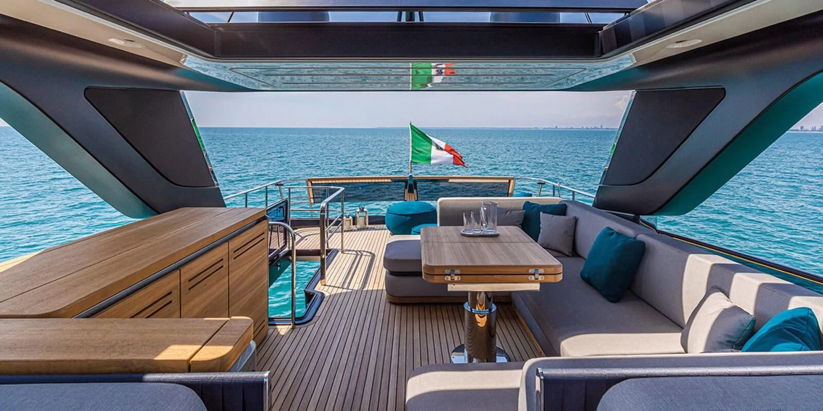 a deck with a table and chairs on it aboard SESSANTASETTE 67 Yacht for Sale