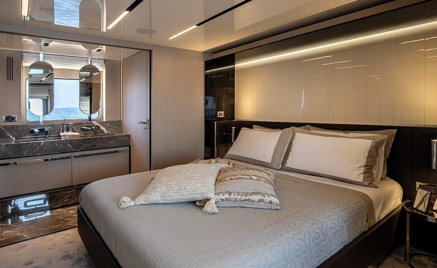 a bed with white sheets aboard SESSANTASETTE 67 Yacht for Sale