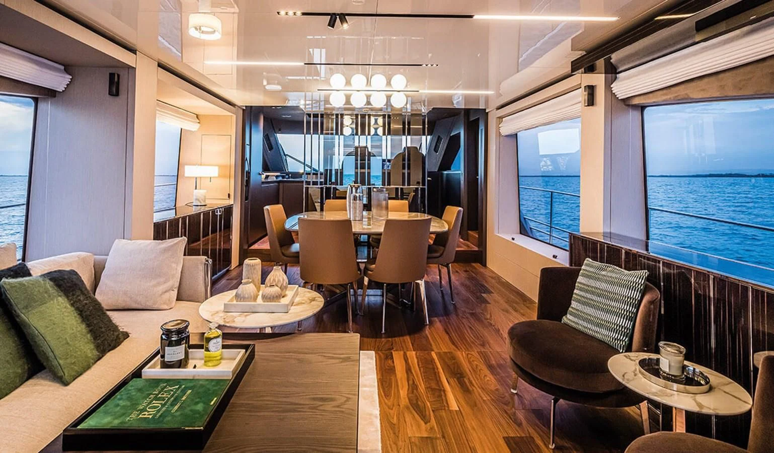 a room with a table chairs and a couch aboard SESSANTASETTE 67 Yacht for Sale