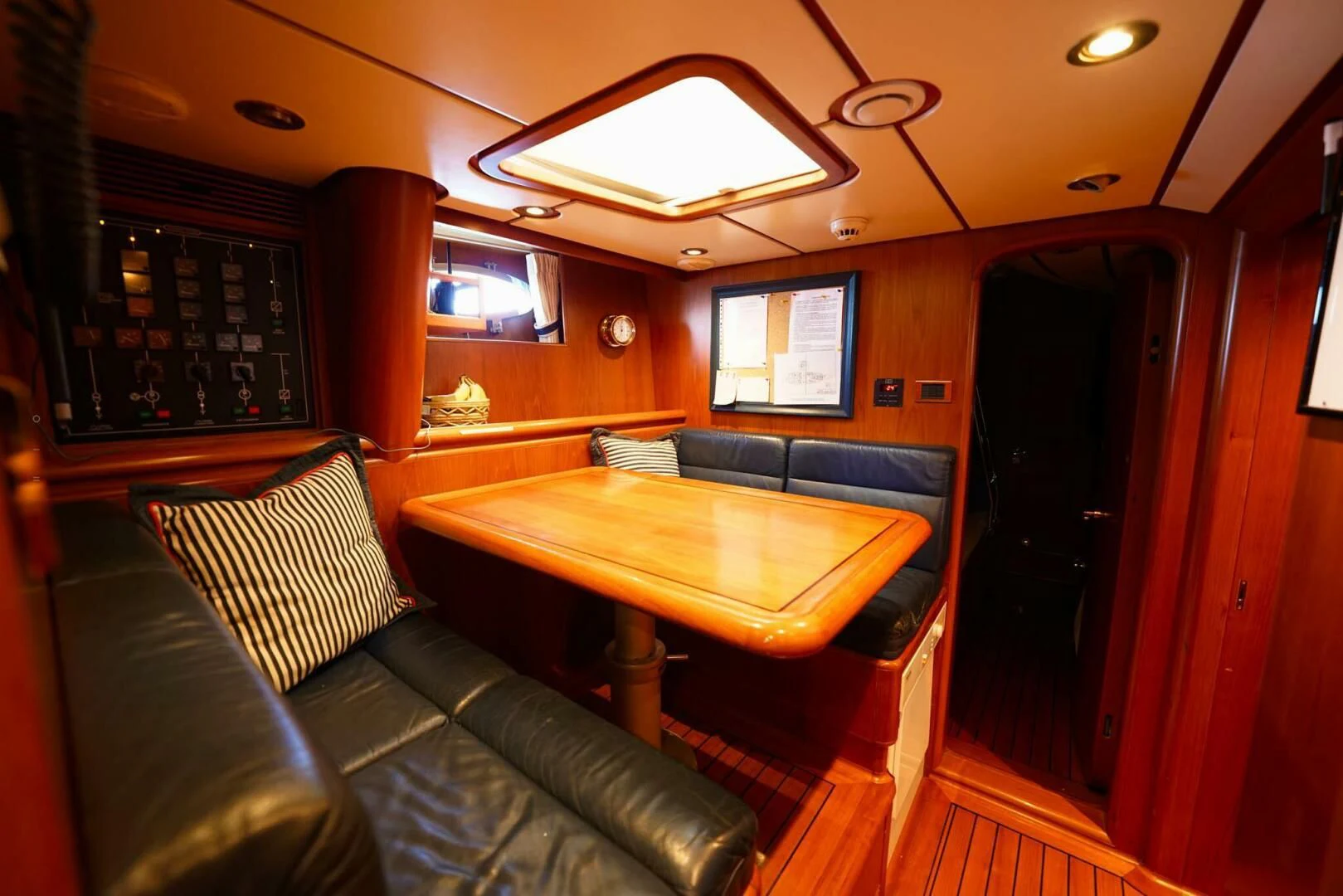 a living room with a couch and a table aboard JERSEY PEARL Yacht for Sale