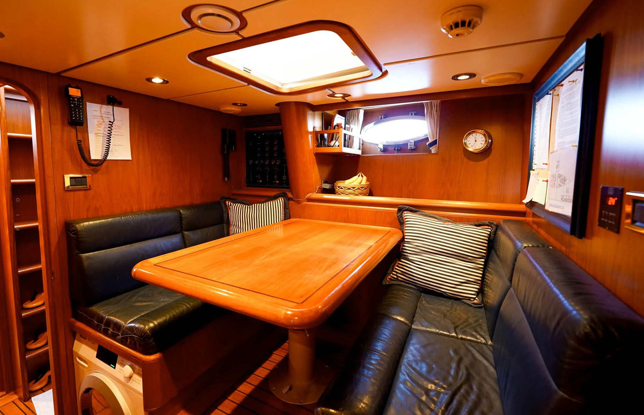 a room with leather couches and a table aboard JERSEY PEARL Yacht for Sale