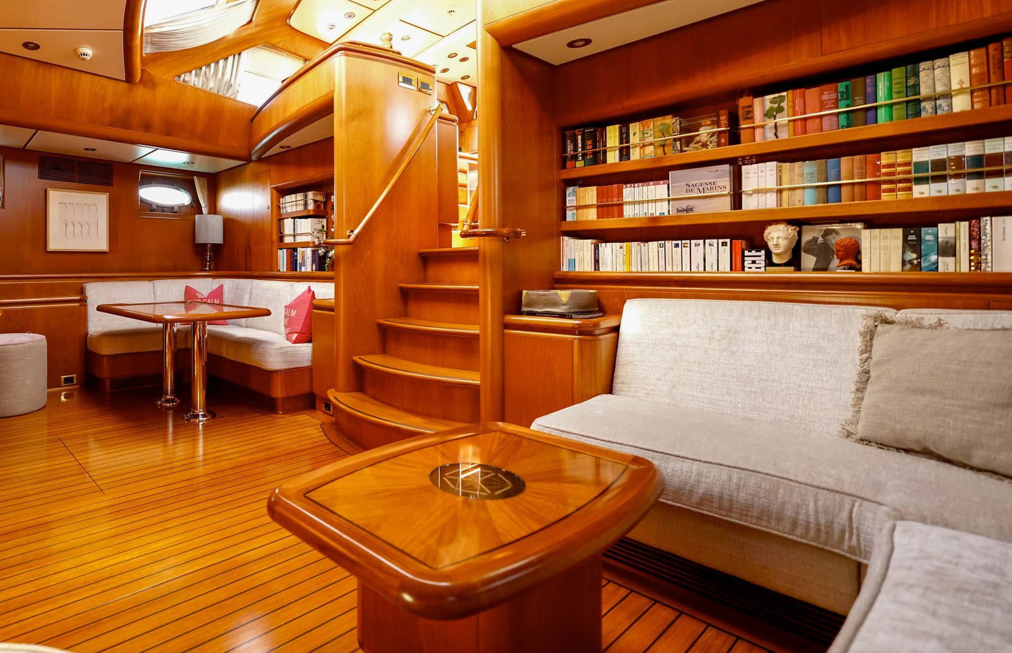 a living room with a bookcase aboard JERSEY PEARL Yacht for Sale