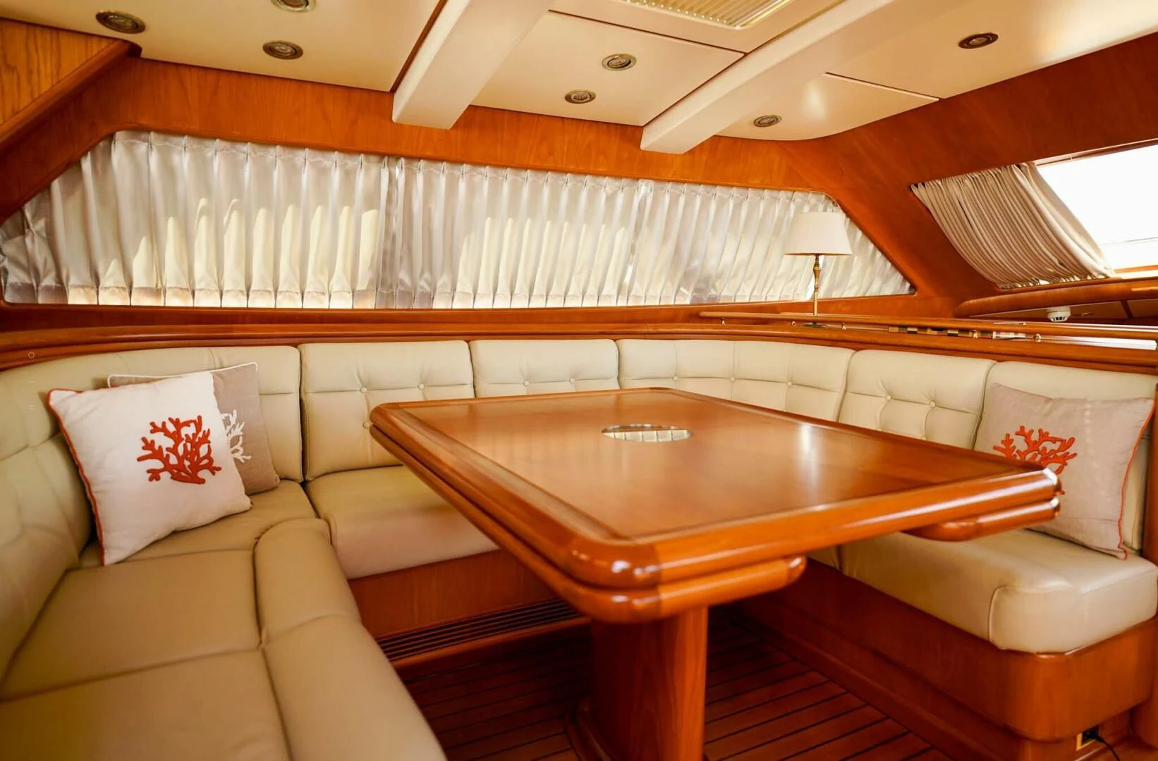 a room with a table and couch aboard JERSEY PEARL Yacht for Sale