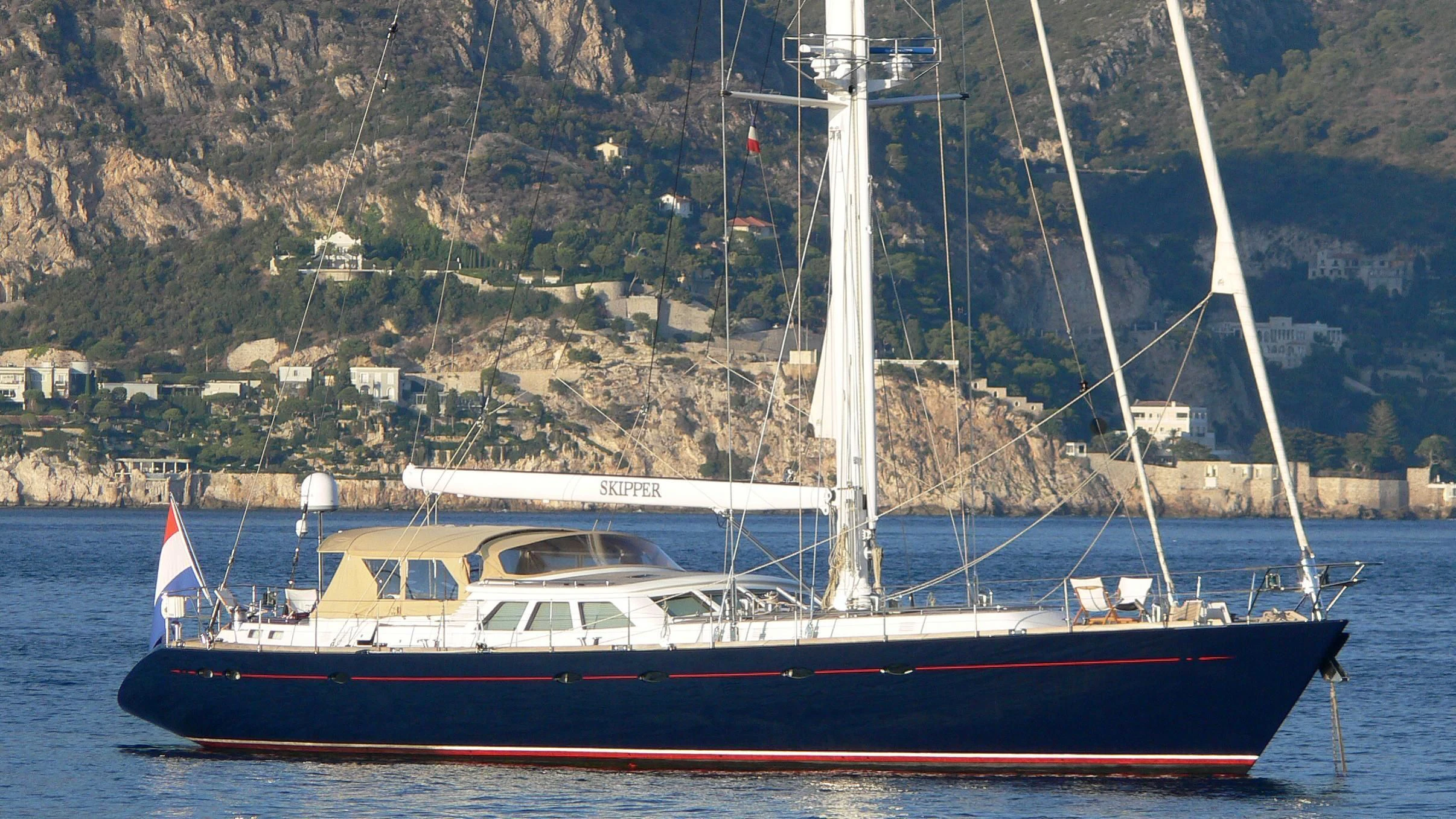 a red and white boat on the water aboard JERSEY PEARL Yacht for Sale